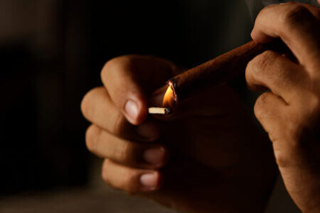 Cuban Cigar Box And Person Smoking Cigar. Habano Cigar Wrapper Is A Leaf Grown From A Cuban Seed, Hence The Word  Cuban Cigar Box And Person Smoking Cigar. Habano Cigar Wrapper Is A Leaf Grown From A Cuban Seed, Hence The Word